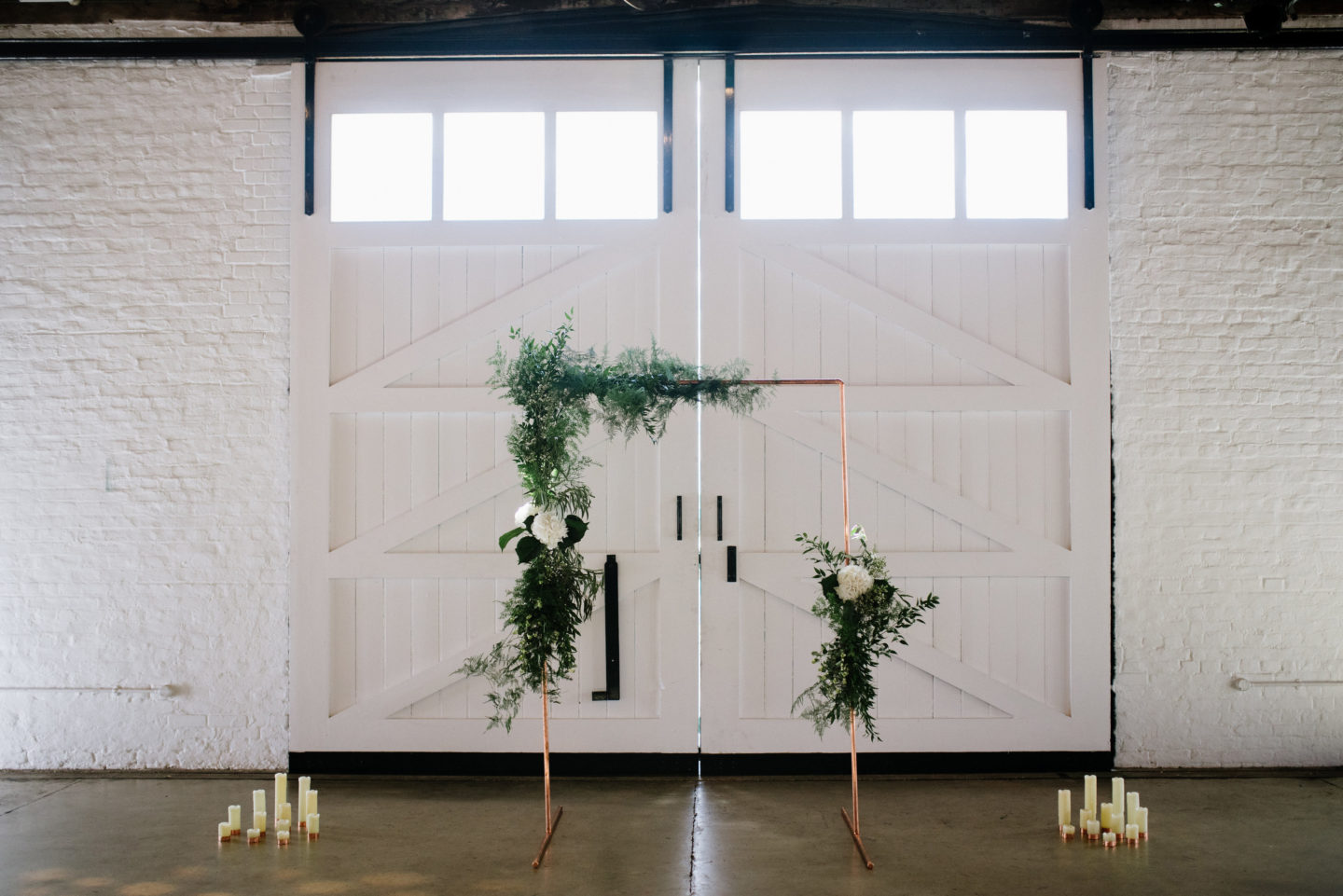 Copper arch for a wedding ceremony. Modern Warehouse Wedding Decor | Industrial Wedding Styling